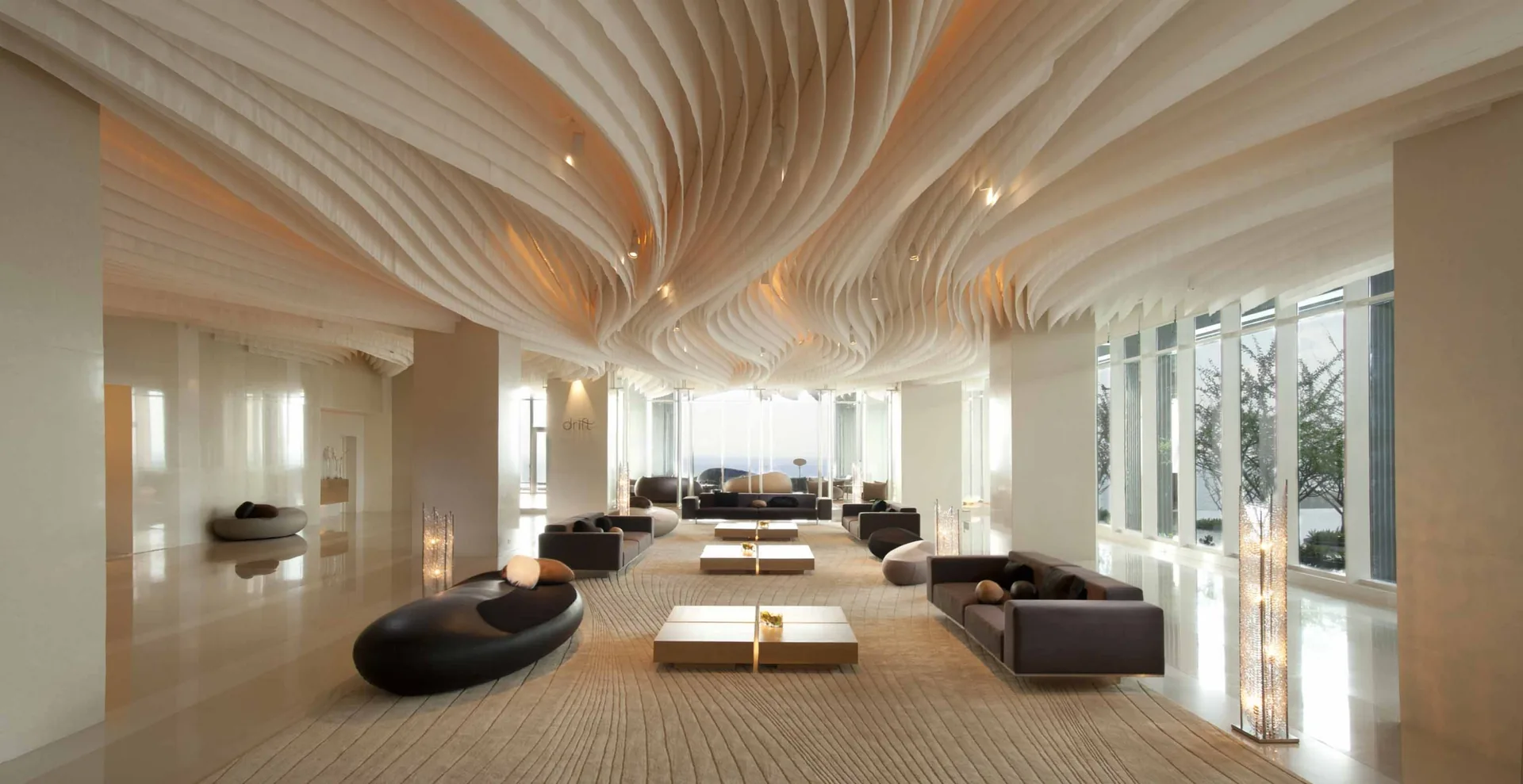 Modern Hilton hotel lobby with sculptural ceiling and lounge seating