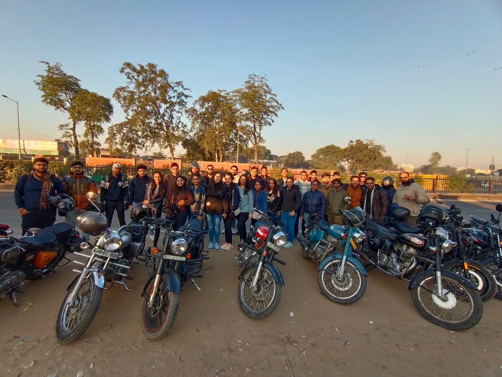 Team members gathering for an outdoor motorcycle outing